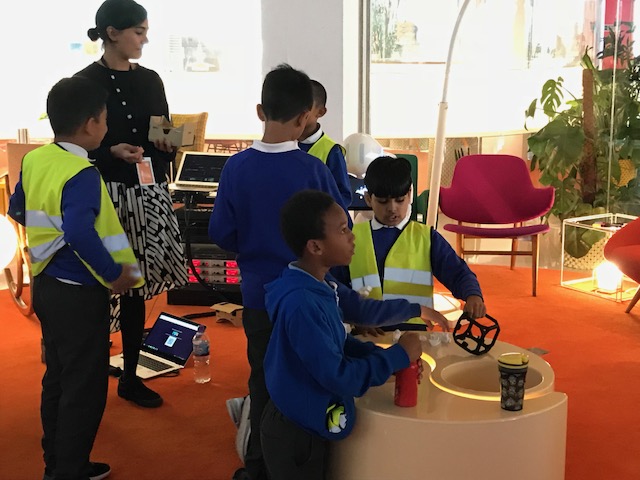 Three school children using augmented reality