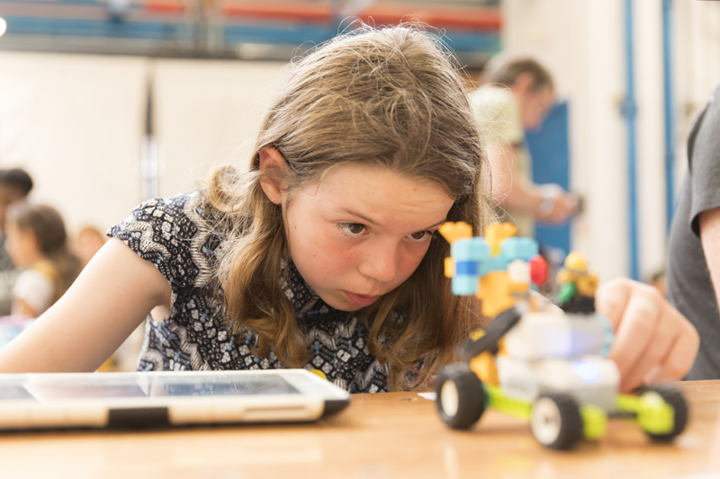 A girl with a LEGO WeDo kit
