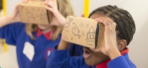 Children with cardboard virtual reality headsets