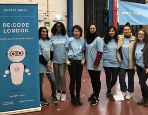 Volunteers standing next to a banner for RECODE London