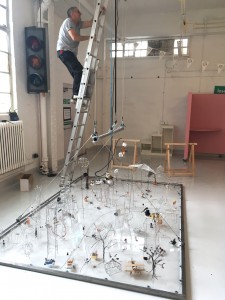 A man on a ladder installing a wire installation